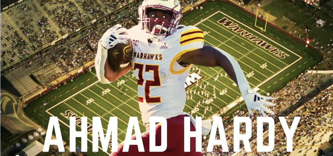 Ahmad Hardy running with the football