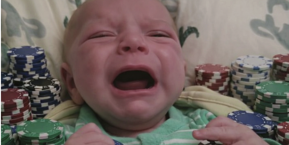 Newborn surrounded by poker chips