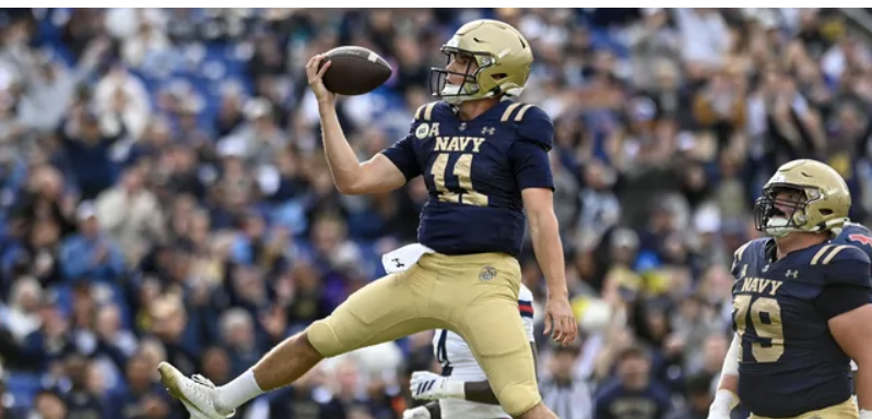 Blake Horvath of Navy throwing a football