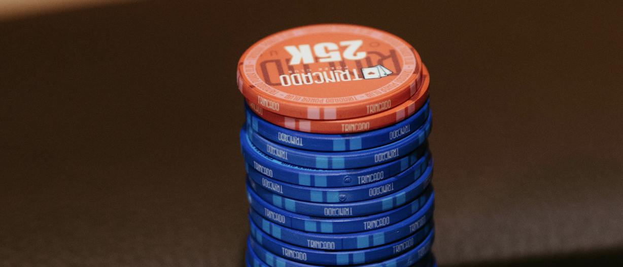 Red casino chips stacked on top of blue chips