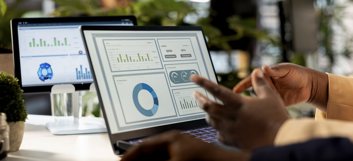 Analyst reviewing centralized player data dashboard on laptop with multiple metrics