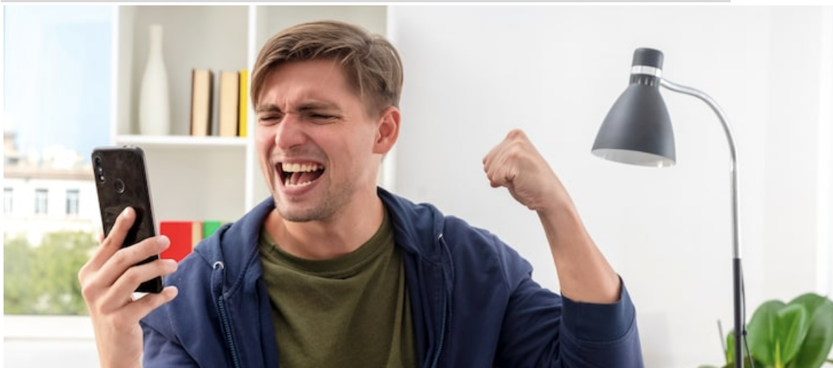 Man celebrating on his iPhone