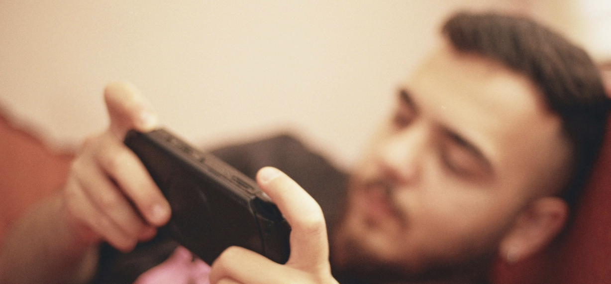 Man on mobile device while on couch