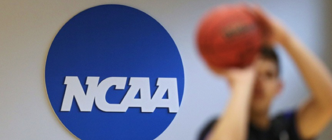 NCAA basketball player shooting ball with logo to the left 