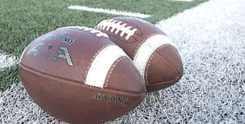 Two footballs on field 