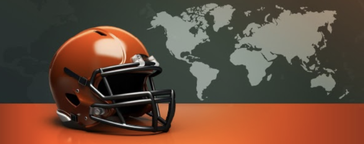 American football helmet on an orange surface with a world map in the background, symbolizing the international expansion of the NFL.