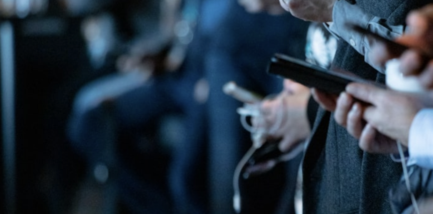 Phone laid next to a chip and lock and emblem of Australia on another device