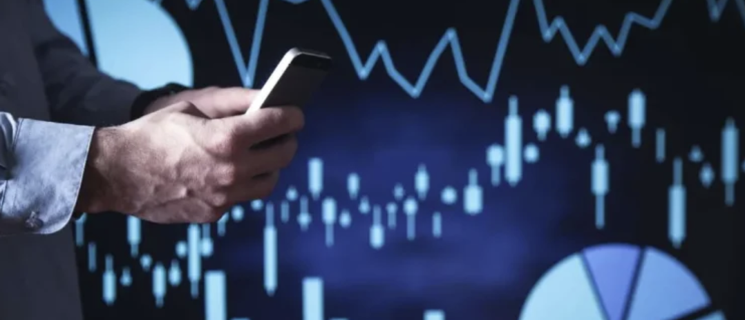 Man on phone with prediction graphs appearing in background