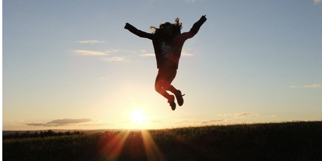 Woman jumping in sunset