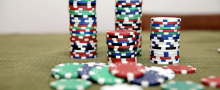 Casino chips all different colors, mostly stacked