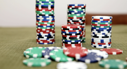 Casino chips all different colors, mostly stacked