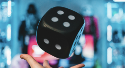 dice tossed into air with blue backdrop