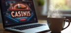 Laptop in front of a cup of coffee
