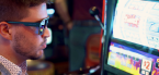 Man with sunglasses playing on a casino machine