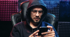 Man with hood and glasses on phone